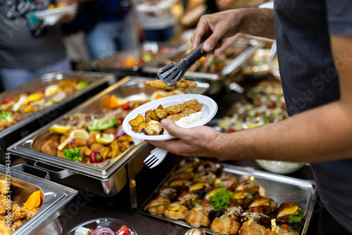Fotografie Gathering of friends enjoying a buffet meal with assorted dishes at a lively eve