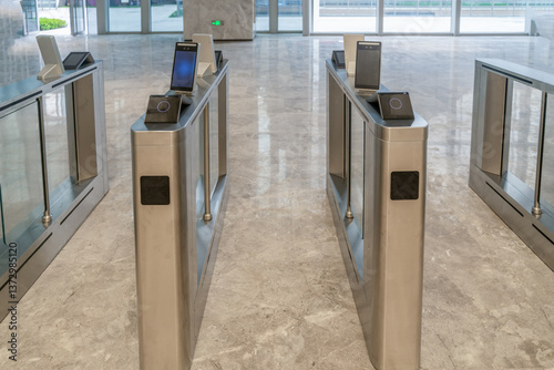 turnstile with access control system in modern office building interior.