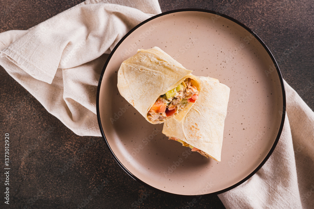 Close up of homemade shawarma with chicken, tomato and cucumber in pita bread top view