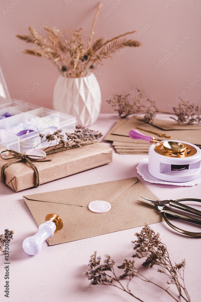 An envelope sealed with wax and a craft kit on the table vertical view