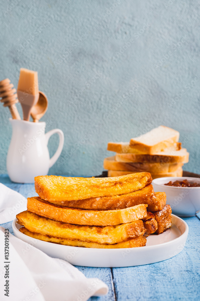French crispy sweet toast on plate on table vertical view
