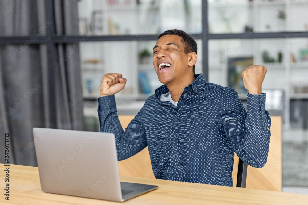 Excited african american man celebrating online success