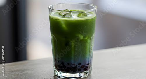 Refreshing iced blueberry matcha latte with boba pearls creating a visually layered drink