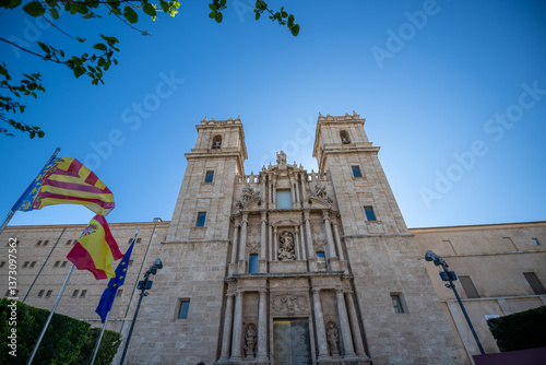 Iconic Historic Building in Valencia Featuring Ornate Facade and Towering Architecture Under a Bright Blue Sky