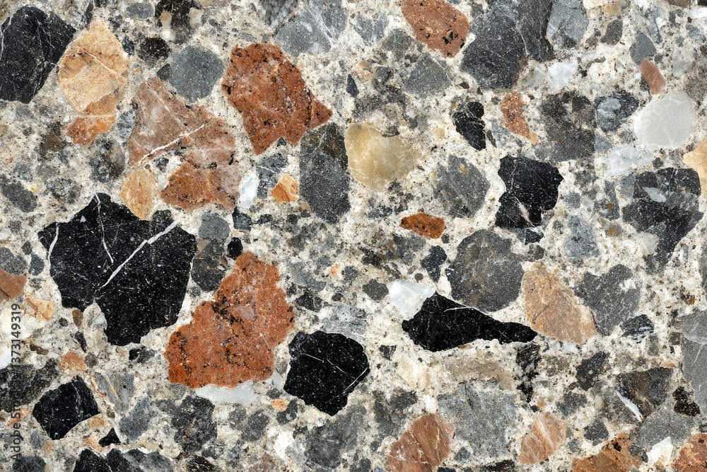 A high-resolution close-up of a terrazzo surface featuring a mix of colorful stone fragments in various sizes.