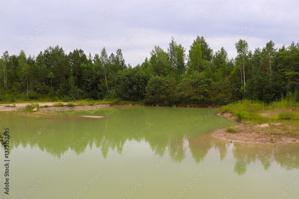 Chalk quarry in Latvia. Forest near turquoise lake. Green water. Chalk quarry in Latvia. Forest near turquoise lake. Green water.