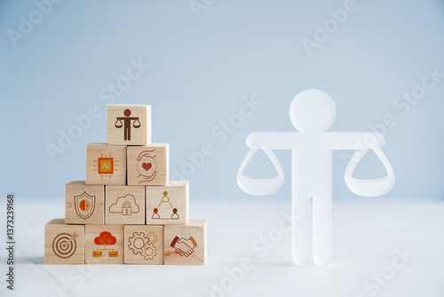 Hand holding wooden block with Ethical icons, business ethics and corporate compliance concept

