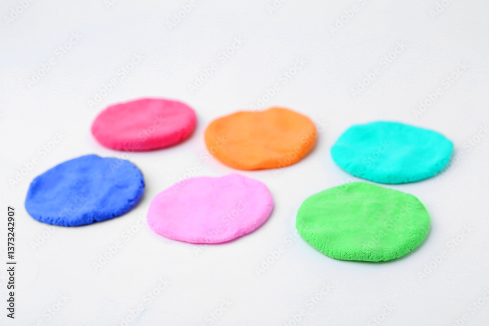 Different colorful play dough on white background, closeup Different colorful play dough on white background, closeup