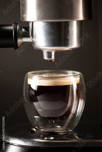 Espresso Shot Dripping into Glass Cup from Coffee Machine