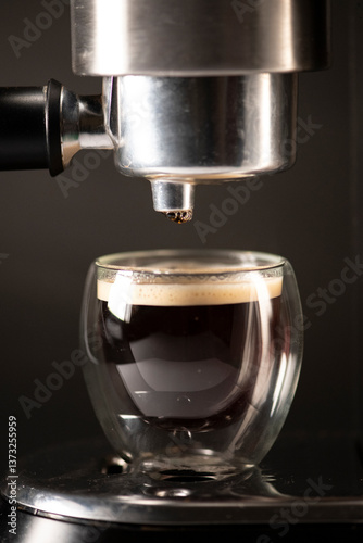 Espresso Shot Dripping into Glass Cup from Coffee Machine