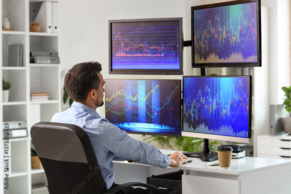 Male trader working at table in office Male trader working at table in office