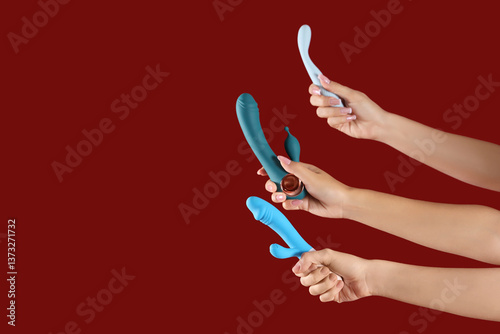 Women with vibrators on red...