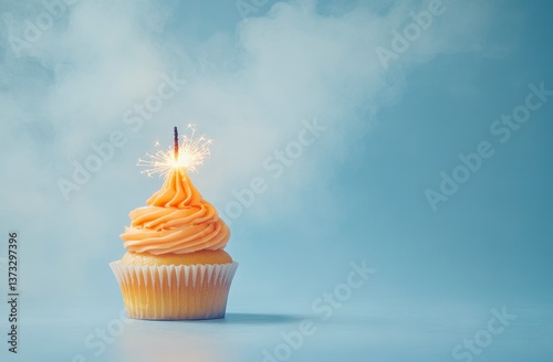 Obraz na płótnie Peach Cupcake with Sparkler on Light Blue Background w salonie