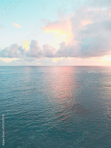 Aerial view of colorful sunrise over ocean in Punta Cana. Breathtaking scenery showcases sky painted with stunning hues, while gentle waves reflect morning light. Perfect postcard capturing tropical