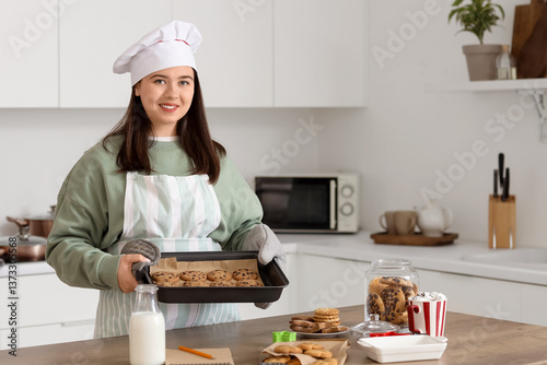 Female chef holding baking ...