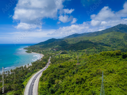 Exotic palm tree coastline road to El Nido at Palawan island, Philippines. Aerial drone photo. Open road trip from Puerto Princesa to El Nido 