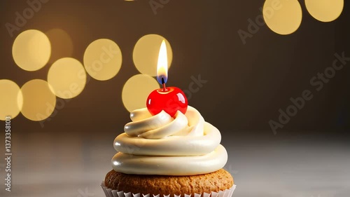 Sweet Celebration: A single cupcake crowned with a lit candle and a cherry on top, creating a festive scene, perfect for any celebration, set against a background of soft, blurred lights. 
