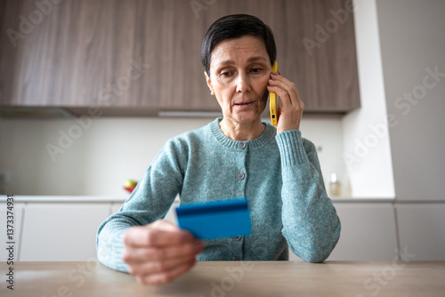 Financial phone scam. Nervous stressed frightened woman sending money to fraudsters via phone. Identity personal data fraud, manipulation, vulnerable target, bank card information, criminal activity