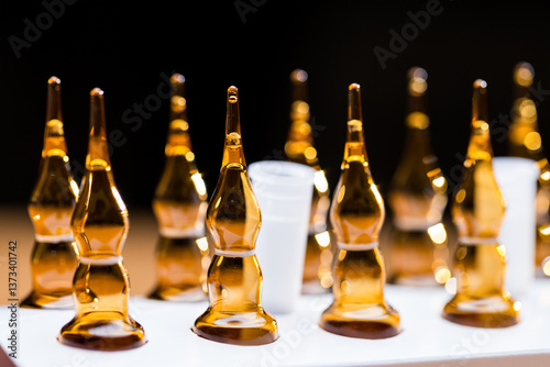 Obraz na płótnie Cosmetic ampoules with liquid skincare serum arranged neatly w salonie