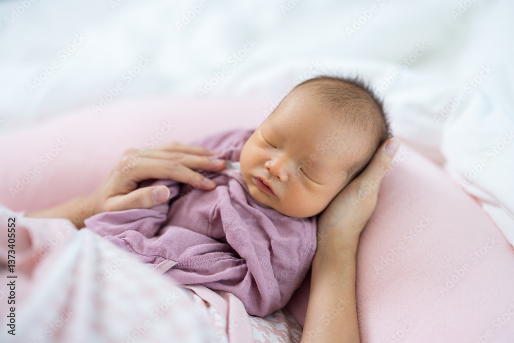 Newborn baby sleeping peacefully in hand