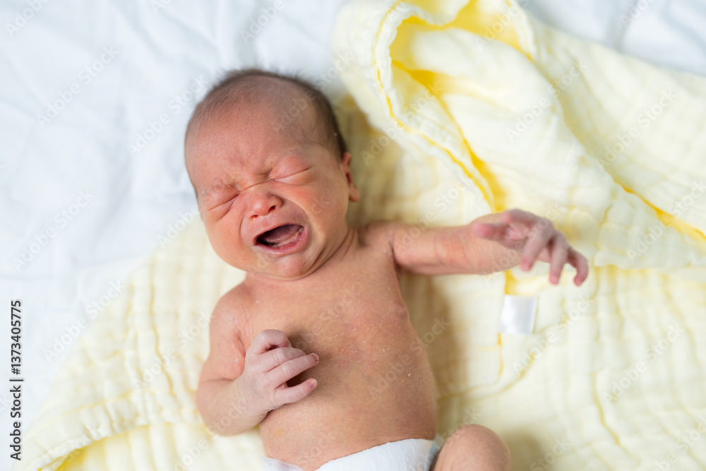 Newborn baby crying with eyes closed