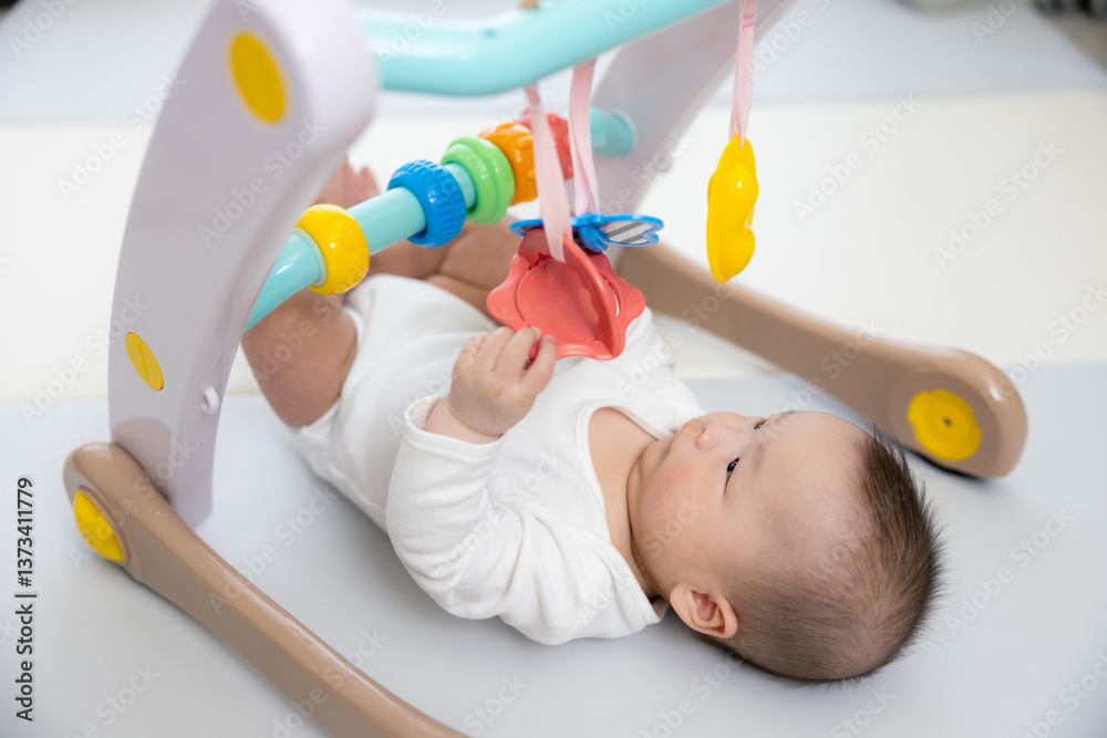 Adorable baby enjoying interactive playtime indoors