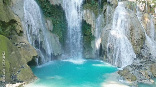 An aerial view showcasing a spectacular Kuang Si Waterfall amid a lush forest, Laos