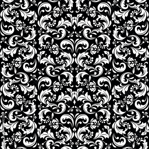 Wallpaper in the style of Baroque. White and black floral ornament. Seamless vector background. Graphic pattern for fabric, wallpaper, packaging. Ornate Damask flower illustration.