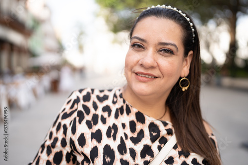 Stylish Latina woman smiling during city trip
