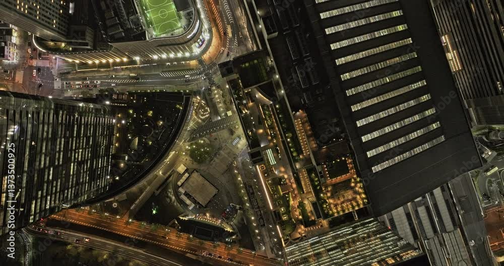 Osaka Japan Aerial v97 vertical top down view flyover Kita Ward, capturing the illuminated buildings and streets, and major railway station in downtown - Shot with Mavic 3 Pro Cine - Oct 9th 2023