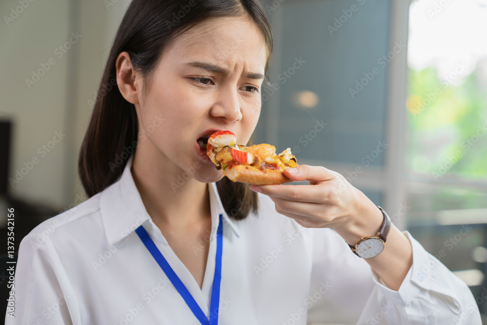 Asian businesswoman eating pizza while working with clients due to rush hour. Asian businesswoman eating pizza while working with clients due to rush hour.