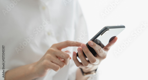 Close-up of hand holding smartphone device and typing text message on online social.