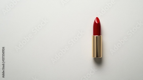 A classic red lipstick bullet standing alone on a white background with copy space