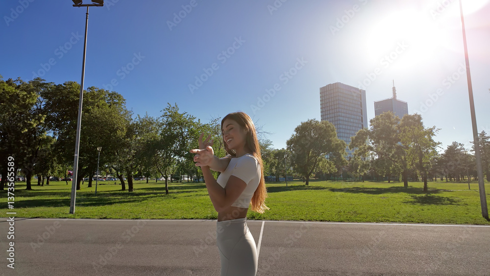 Young woman stretching after exercise and jogging in urban park