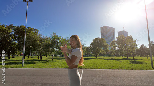 Obraz na płótnie Young woman stretching after exercise and jogging in urban park w salonie