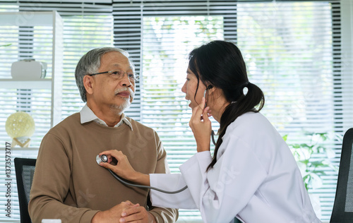 Doctor Using Stethoscope to Check Senior Patient's cardiology and respiratory in Hospital