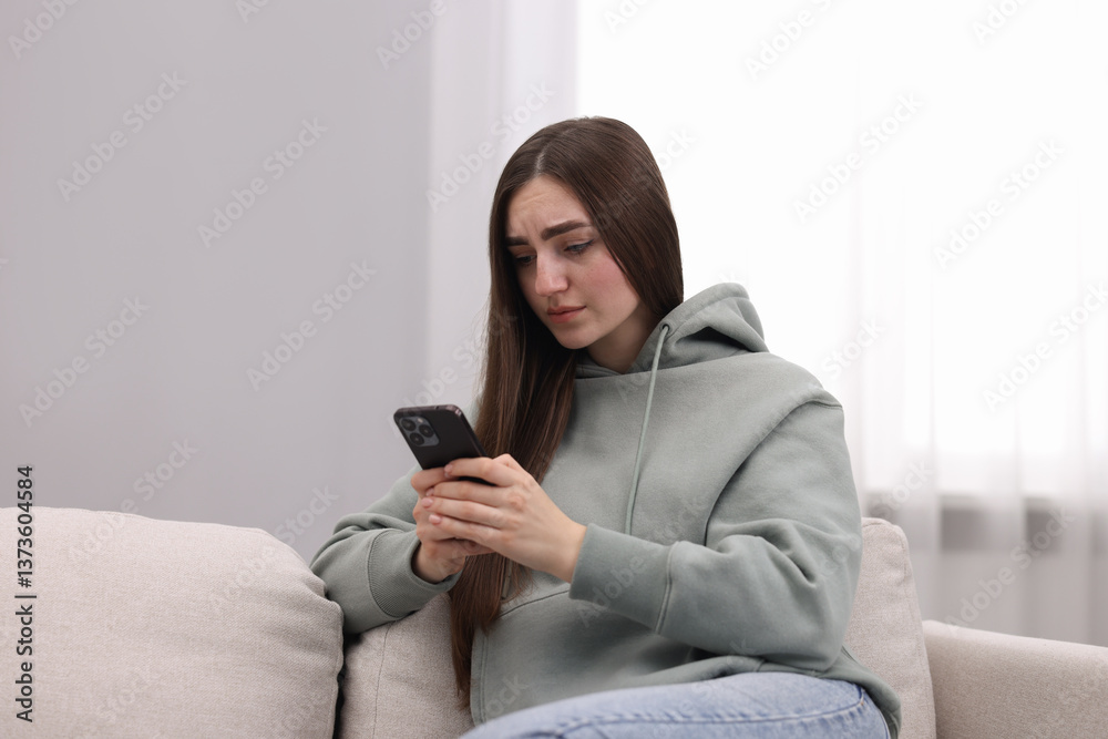 Depressed woman calling hotline for mental health help on sofa at home Depressed woman calling hotline for mental health help on sofa at home
