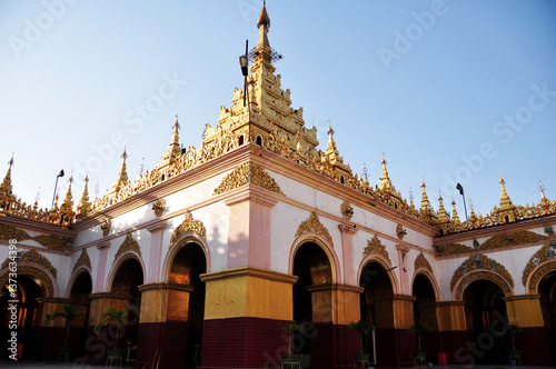 Ancient building of Mahamuni Paya Pagoda Temple and pilgrimage site for burmese people foreign travelers travel visit respect praying Maha Myat Muni Golden buddha statue in Mandalay, Myanmar or Burma photo