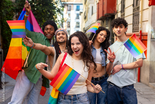 Young activists holding rainbow flags celebrating gay pride in the city photo
