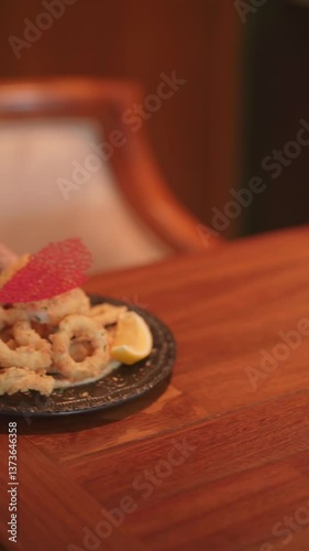Deliciously crispy fried calamari platter upscale restaurant food photography cozy interior close-up view culinary delight for seafood lovers