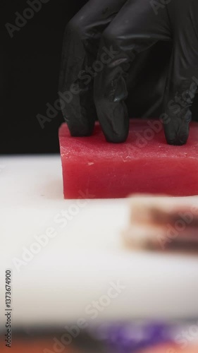 Slicing fresh tuna for culinary mastery sushi restaurant food preparation busy kitchen close-up view art of cooking