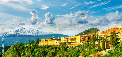beautiful landscape of Taormina town, Italy, Sicily with scenic view at San Domenico hotel near nice buildings and panoramic view of Etna mountain on background
