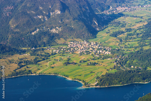 Aerial view of Bohinj lake, Stara Fuzina, Srednja Vas v Bohinju and Studor v Bohinju villages and surrounding cultivated fields, forests and mountains in Gorenjska, Slovenia, seen from Vogel