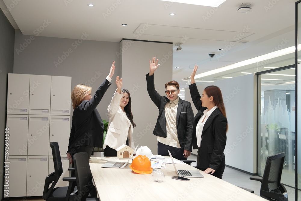 Group of Asian men and women standing together in conference room celebrating successful work, shaking hands