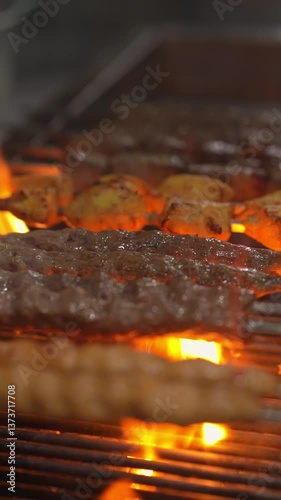 Grilling delicious kebabs over open flames food preparation area culinary art vibrant kitchen environment close-up perspective flavorful cooking concept