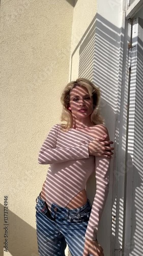 Beautiful slim blonde woman and light and shadow on her face