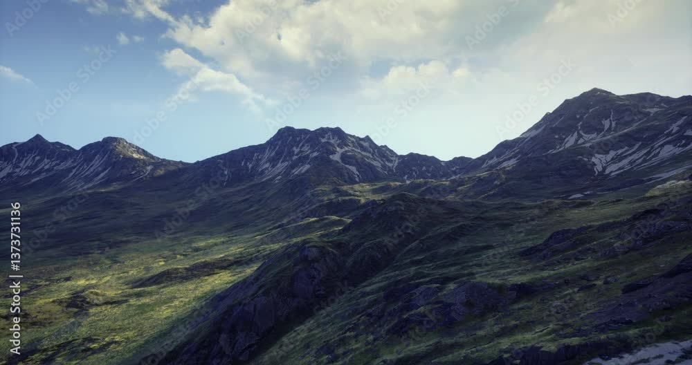 Rugged mountain peaks rise majestically against a backdrop of light clouds and vibrant green slopes, showcasing the beauty of untouched nature in bright daylight. Rugged mountain peaks rise majestically against a backdrop of light clouds and vibrant green slopes, showcasing the beauty of untouched nature in bright daylight.