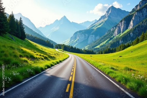 Asphalt ribbon winding through a verdant valley, flanked by majestic mountains under a bright sky
