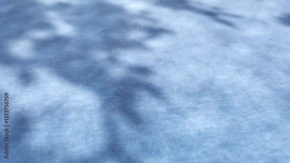 Blurred shadow of tree branches moving on blue background