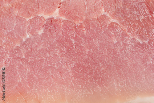 A close-up, macro shot of a raw pork chop, showcasing its fine texture and marbling